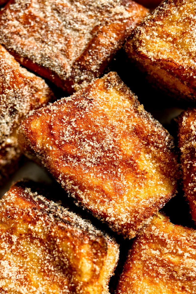 a close up of hawaiian roll french toast bites.