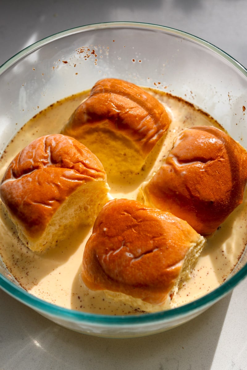 hawaiian rolls soaking in french toast batter.