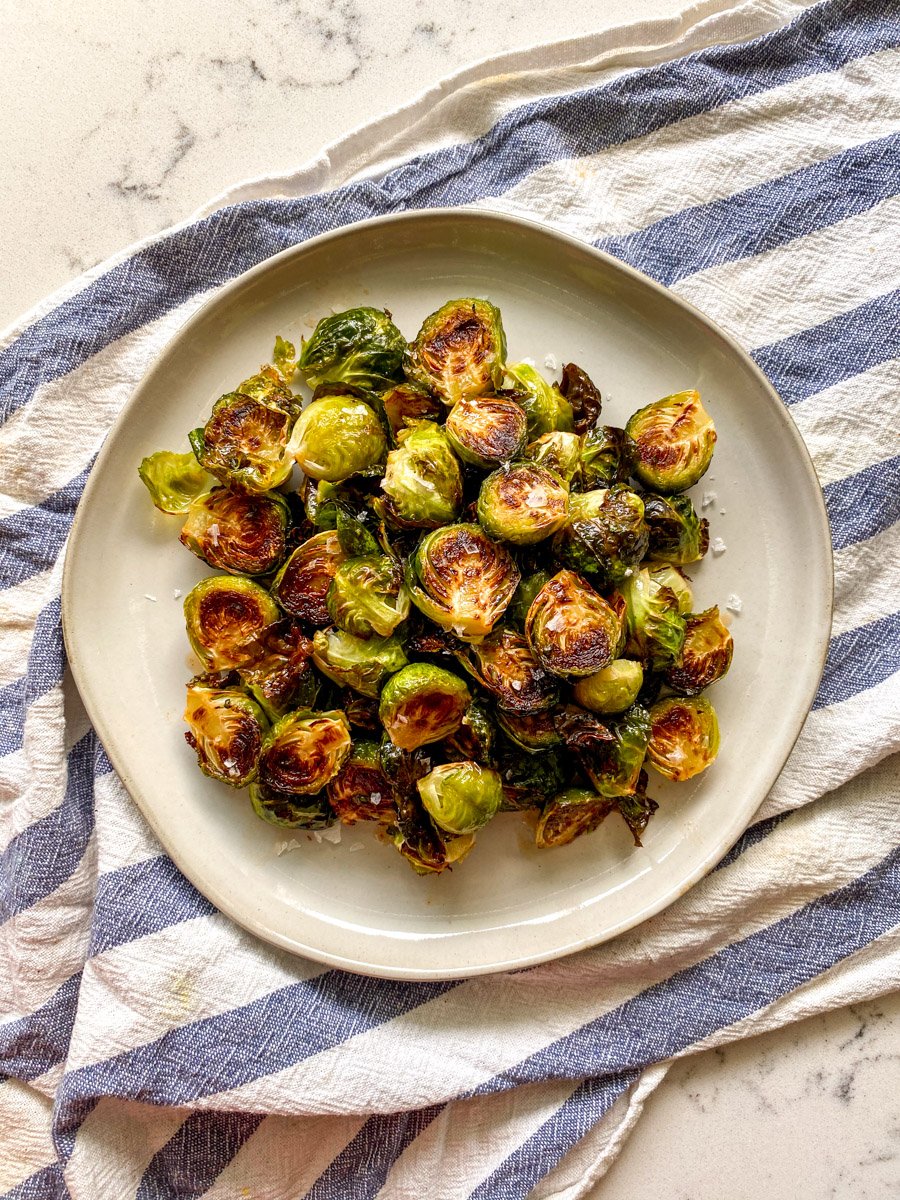 honey sriracha brussel sprouts on a white plate.