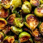 a close up of golden honey sriracha roasted brussels sprouts.