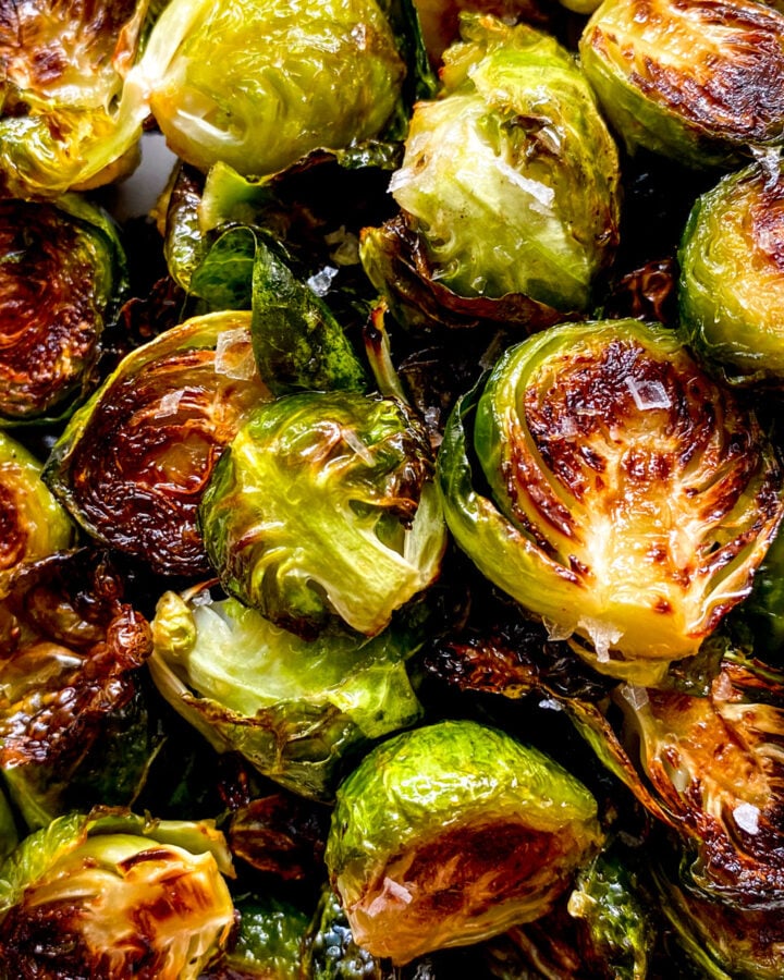 a close up of golden honey sriracha roasted brussels sprouts.