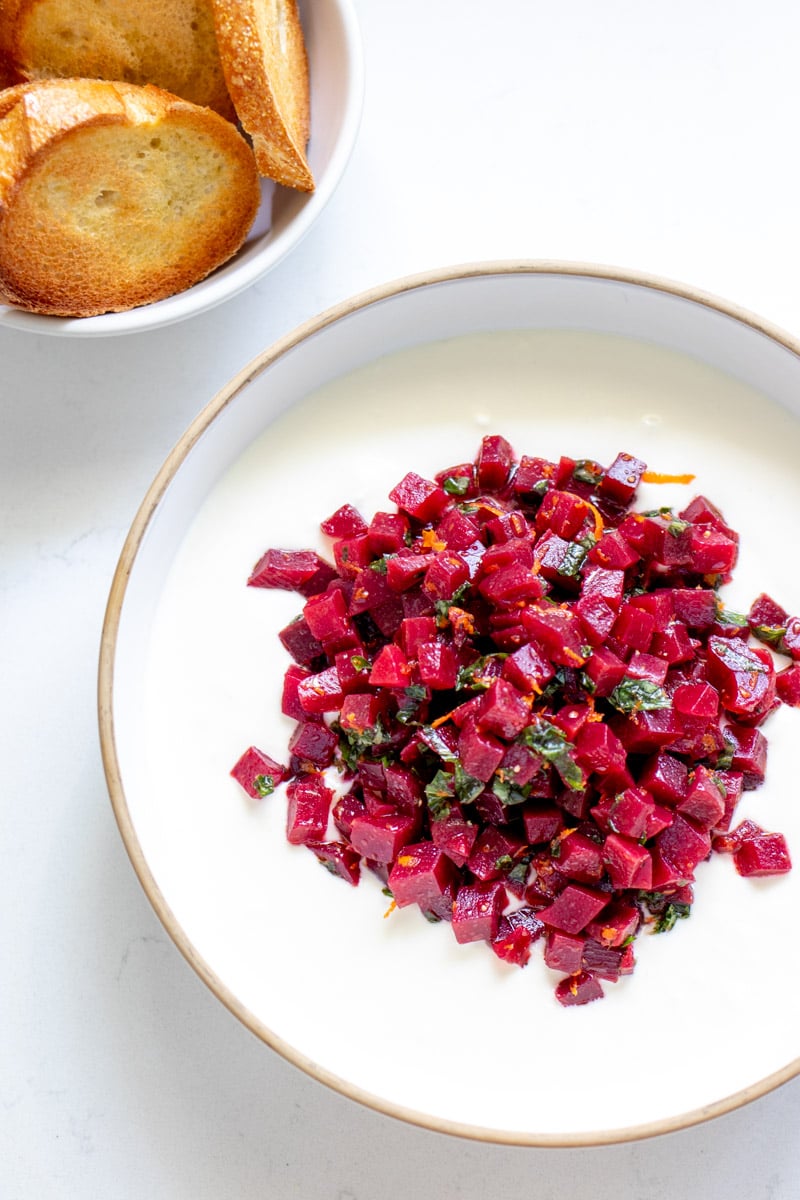 a bowl of whipped hot honey feta and pickled beets.