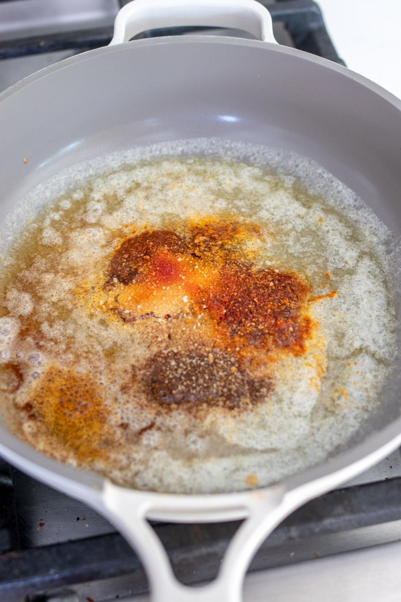 nashville hot butter being made in a small frying pan. 