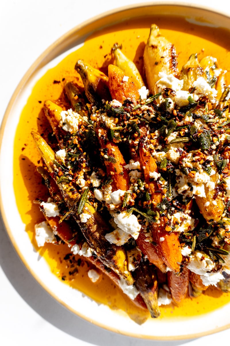 the right side of a white plate full of thanksgiving chili crisp roasted carrots.