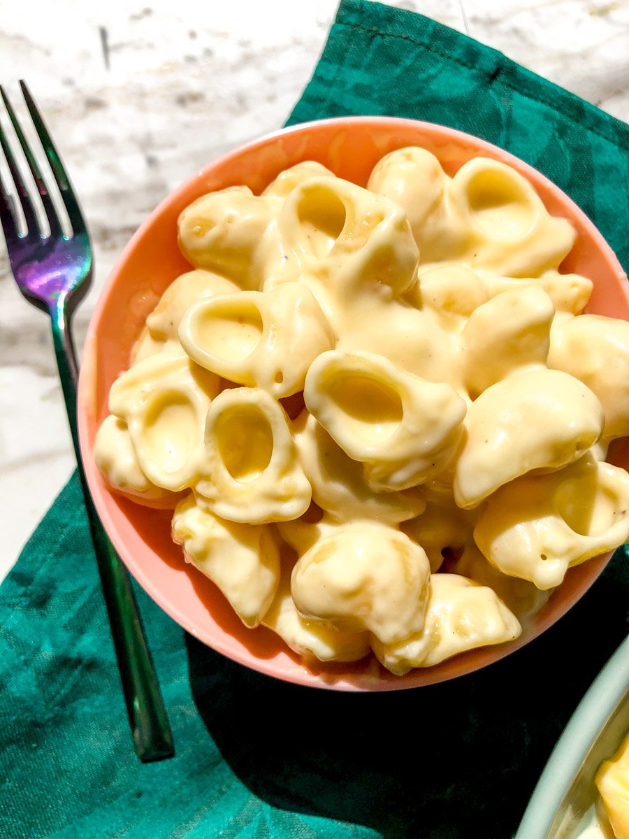 an up close view of a serving cup of mac n cheese.