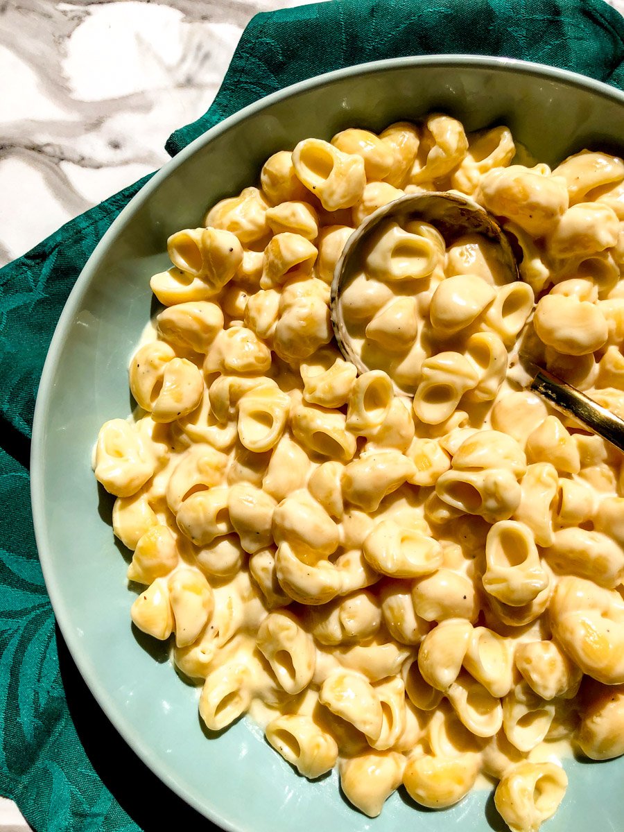 the upper right side of a bowl of white cheddar macaroni and cheese.