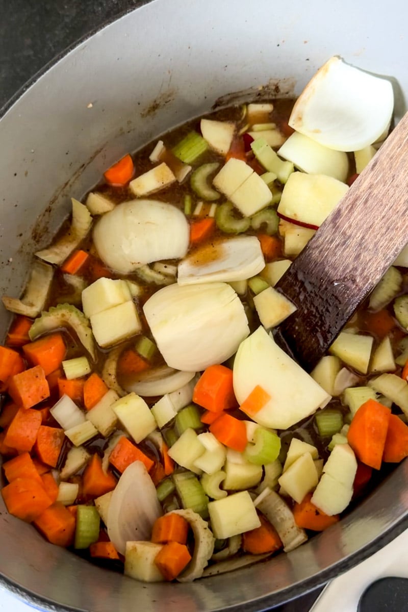 veggies in a blue dutch oven pot.