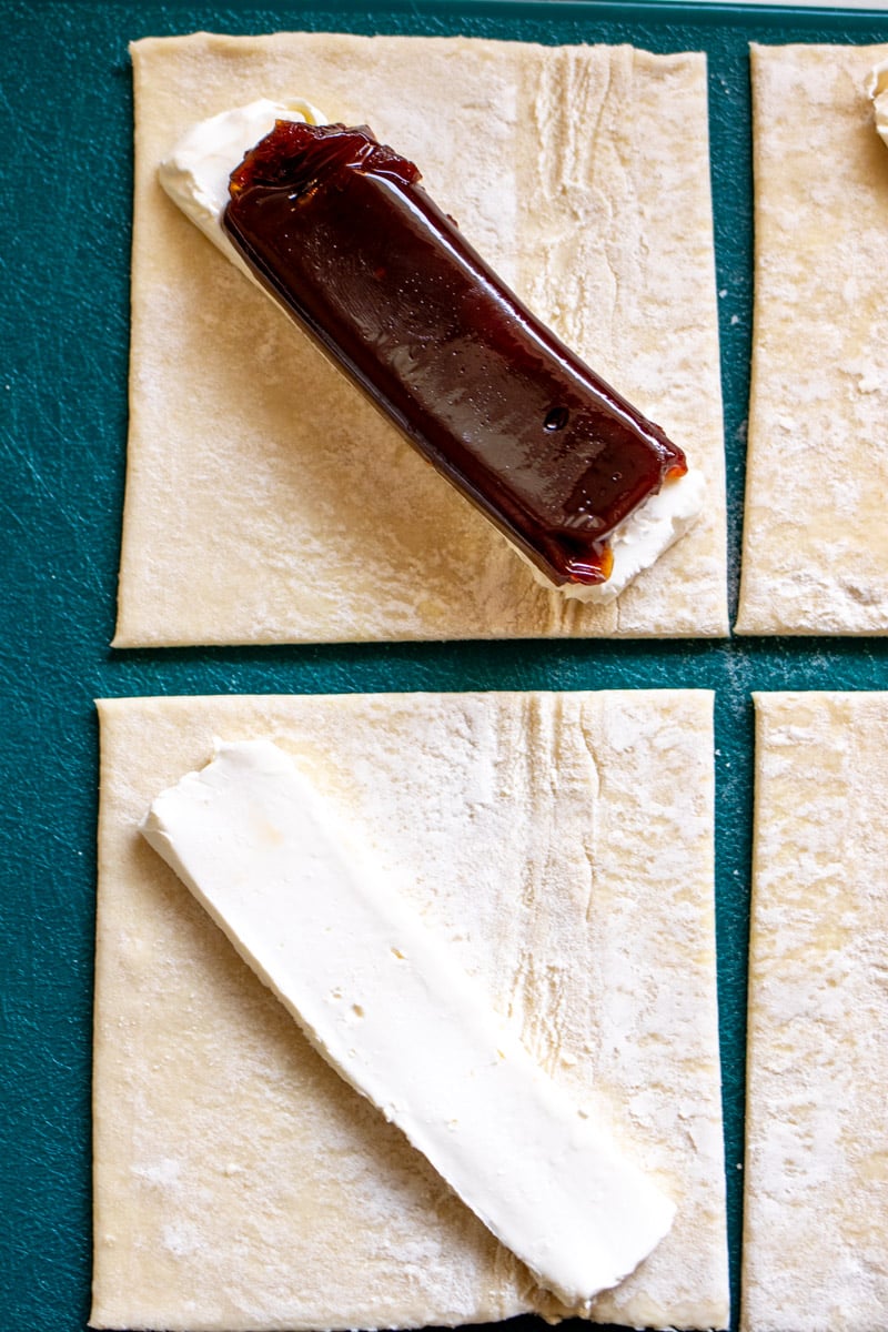 slices of cream cheese and guava on a piece of puff pastry.