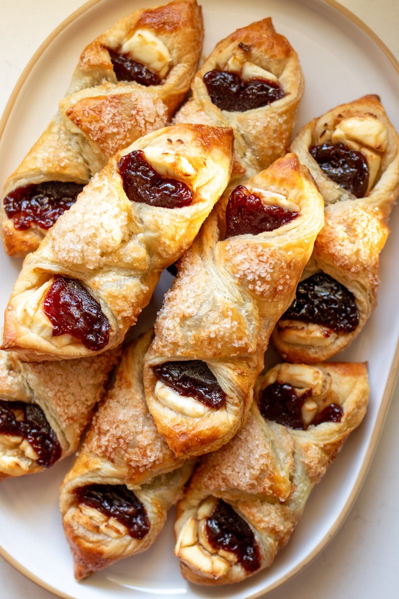 a white platter topped with 8 cuban inspired guava and cream cheese pastries.