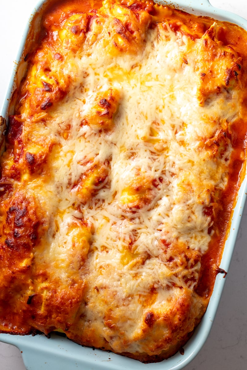 an overhead view of a baked lazy lasagna in a blue baking dish.