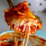 a spoon holding a cheesy scoop of lazy lasagna.