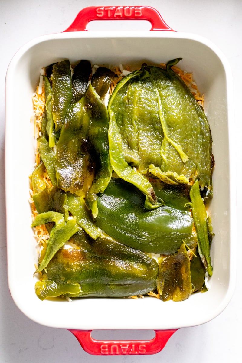 an assembled chile relleno casserole on a baking dish.