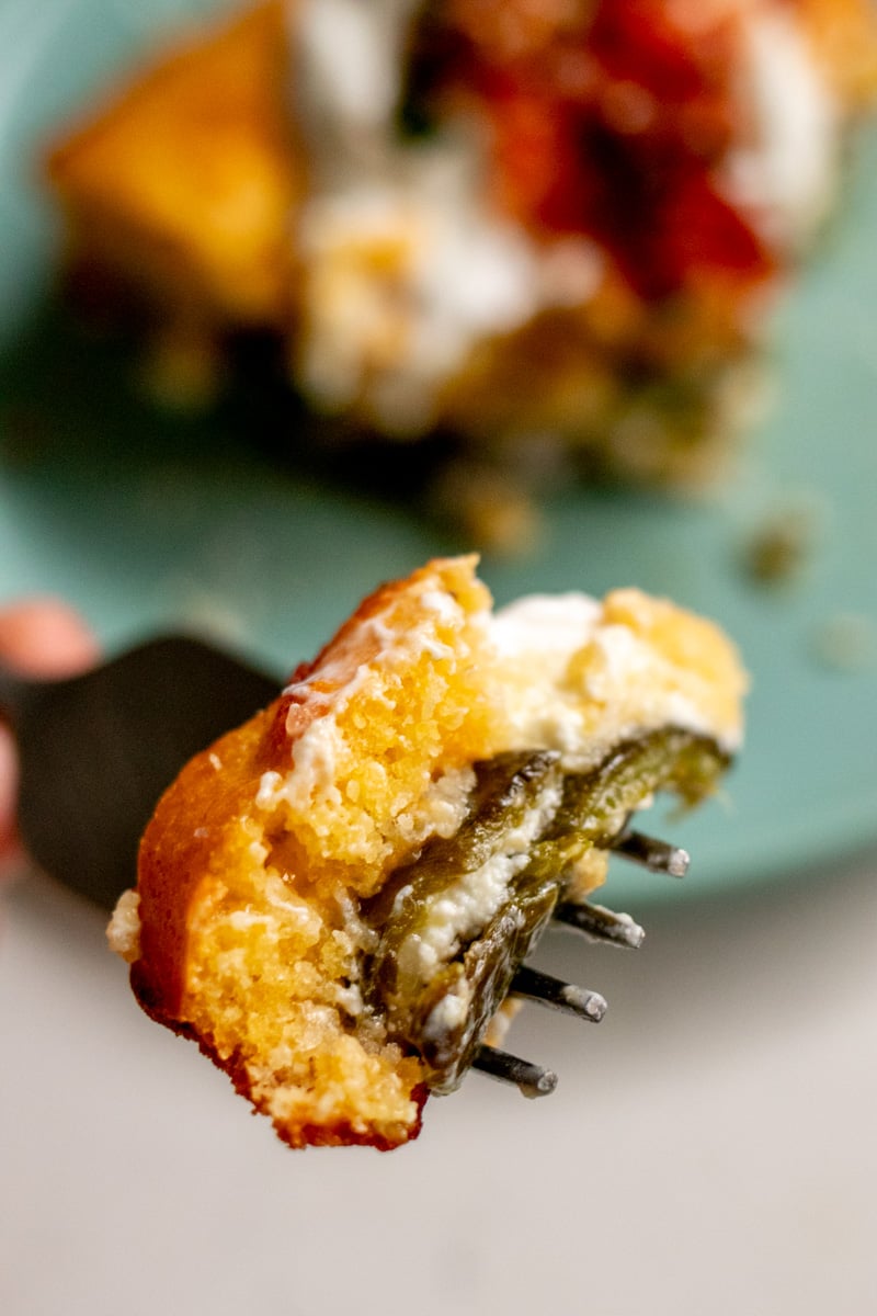 a fork holding a bite of chile relleno casserole.