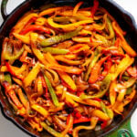 a cast iron skillet full of colorful fajita veggies.