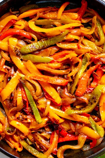 a cast iron skillet full of colorful fajita veggies.