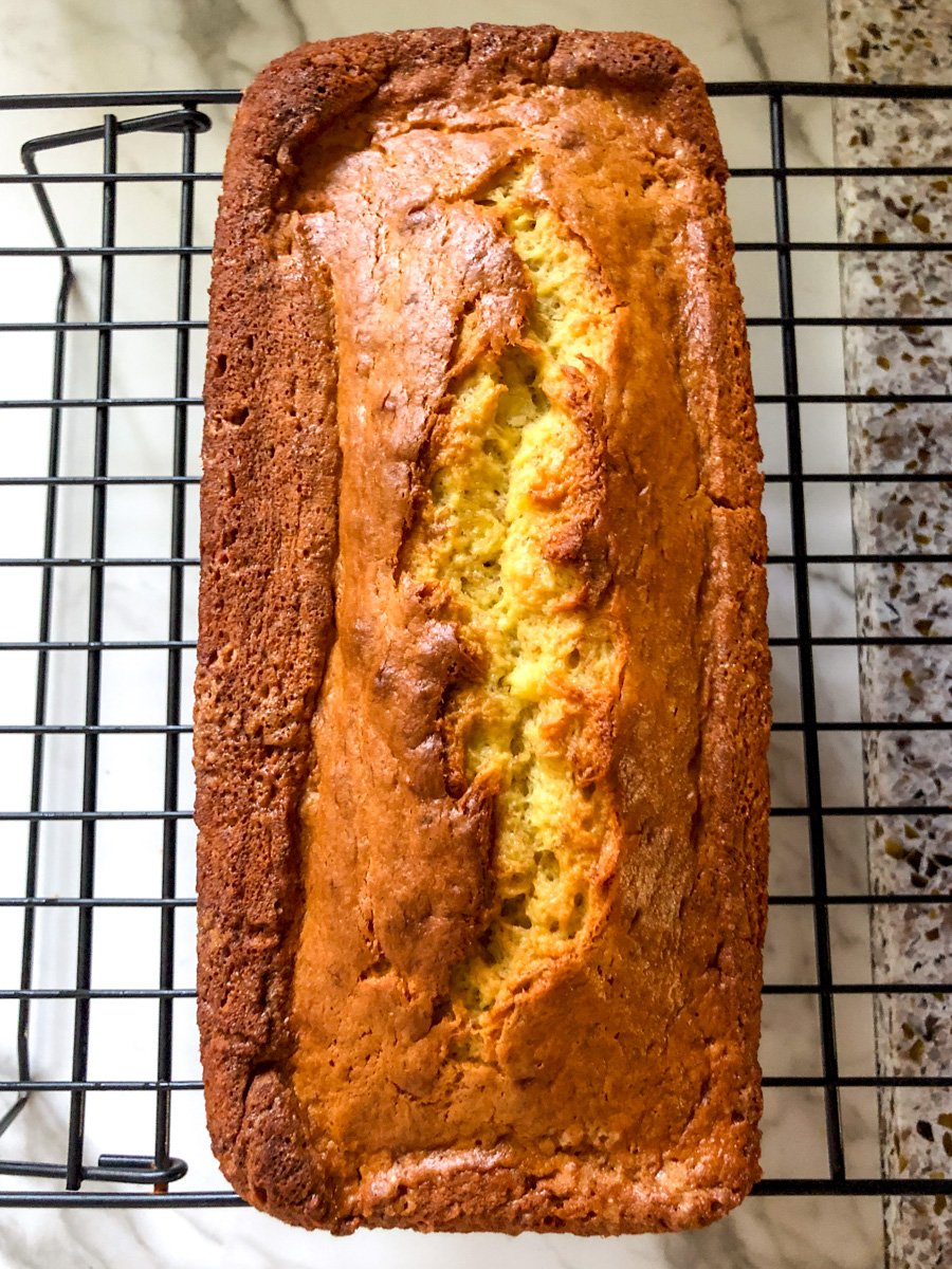 a large loaf of cake mix banana bread on a cooling rack.