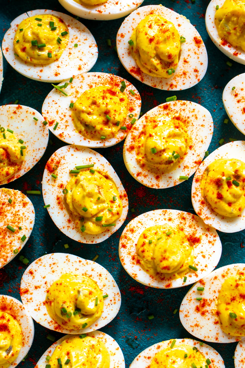 deviled eggs dusted with paprika and chives.