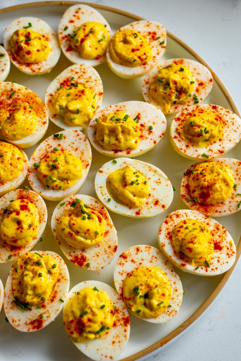 a white plate full of deviled eggs that are made with relish.