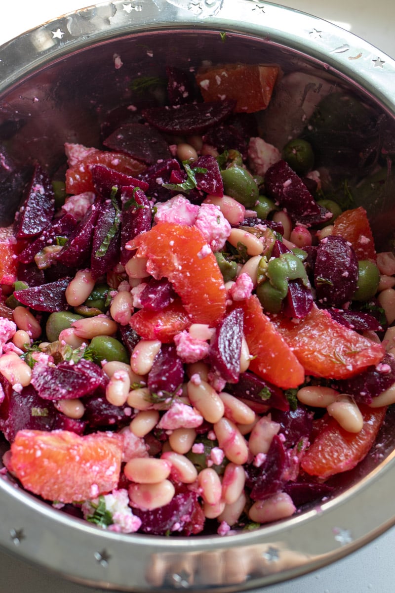 beet and feta salad tossed together in a silver bowl.