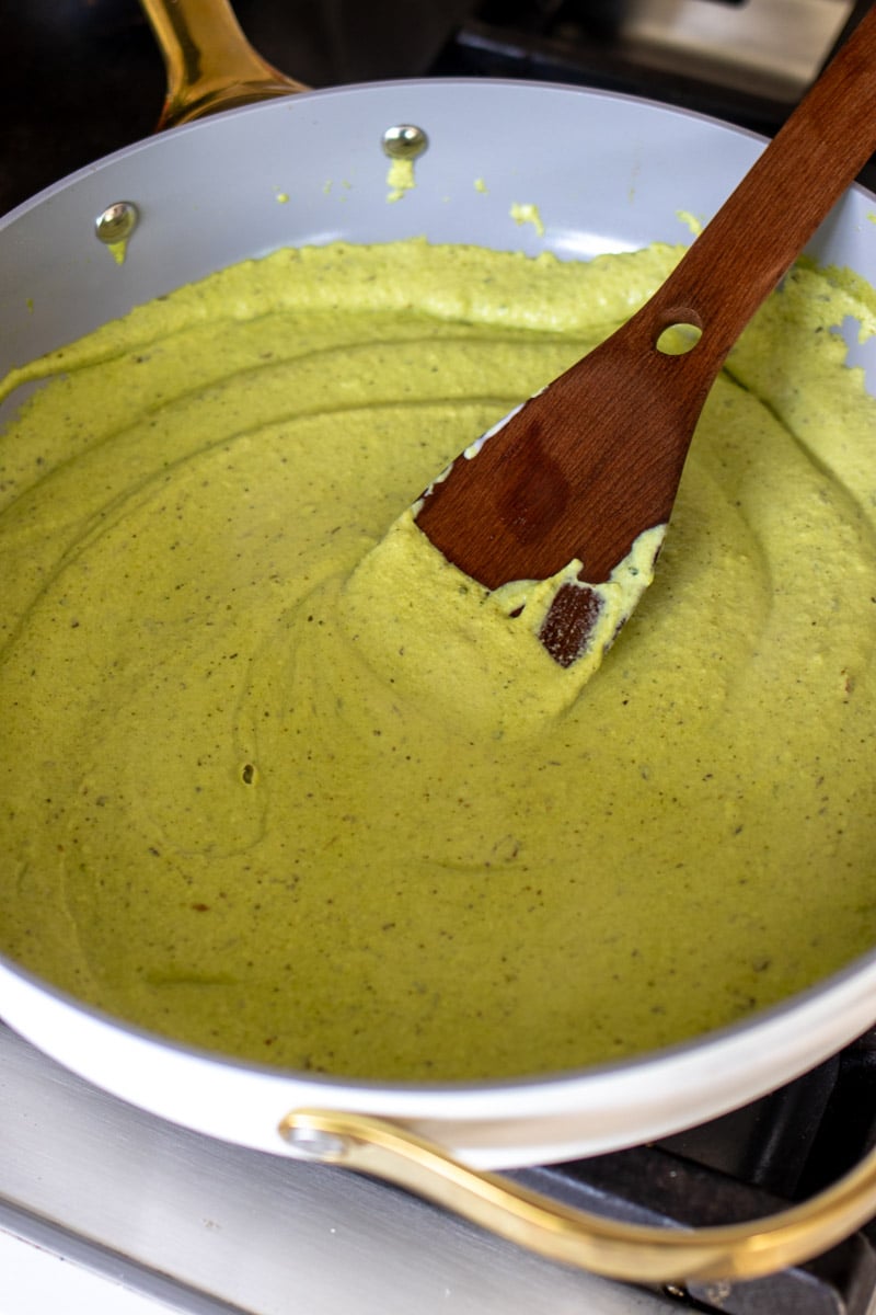 bright green broccoli pesto pasta sauce in a sauce pan. 