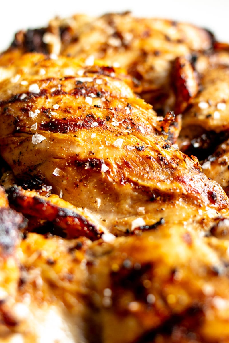 a close up of the char and grill marks of a boneless skinless chicken thigh. 