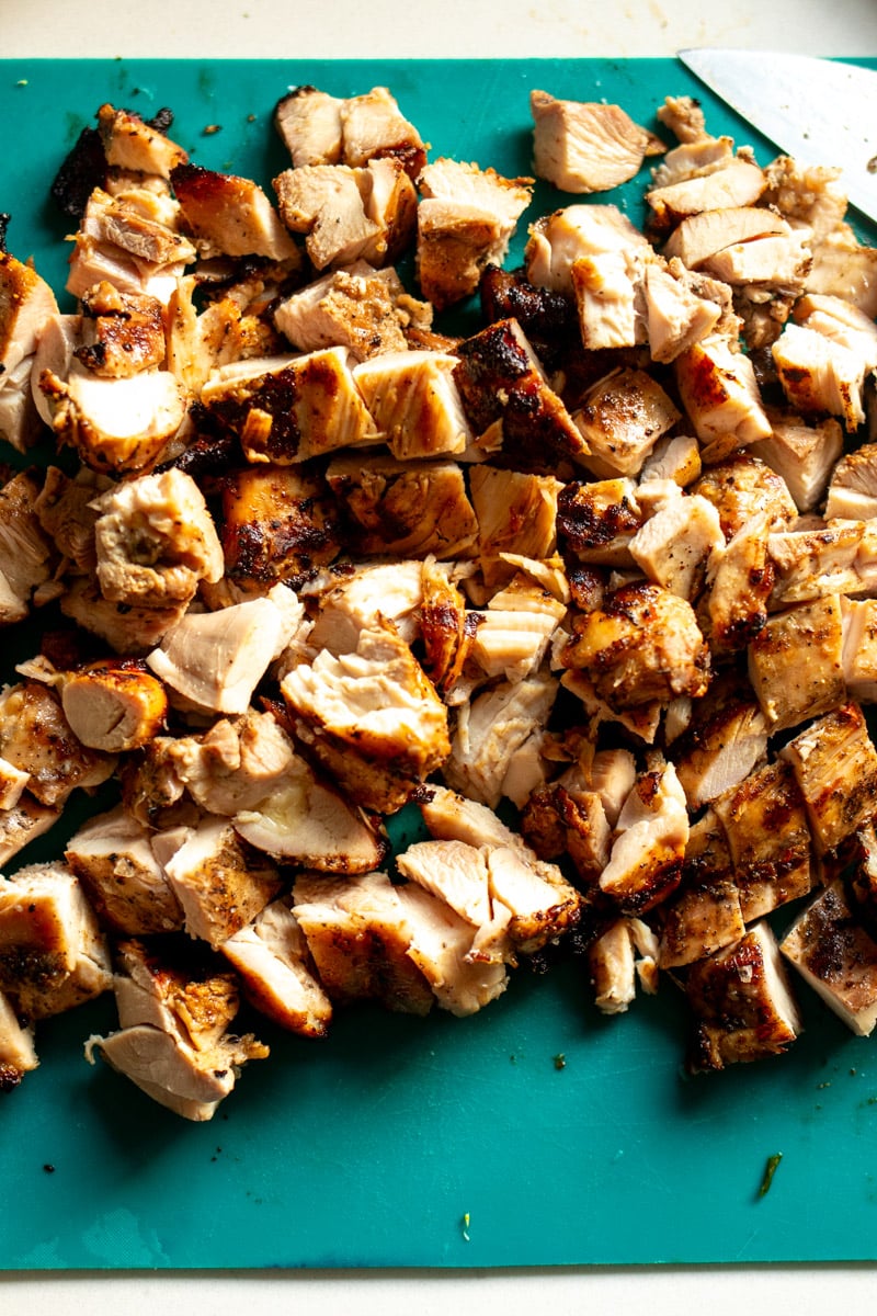 chopped grilled chicken on a cutting board. 