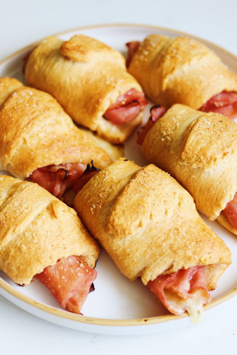 a plate of ham and cheese roll ups. 