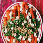 a white plate filled with hot honey glazed carrots.