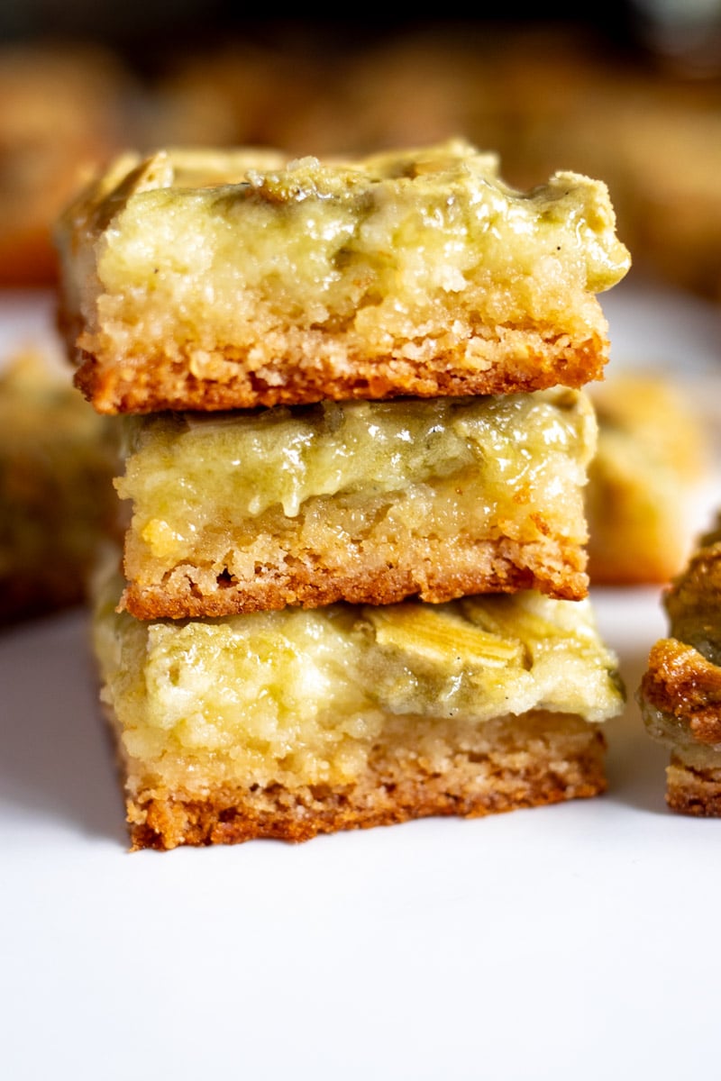 3 pistachio cream gooey butter cake pieces stacked on top of each other.