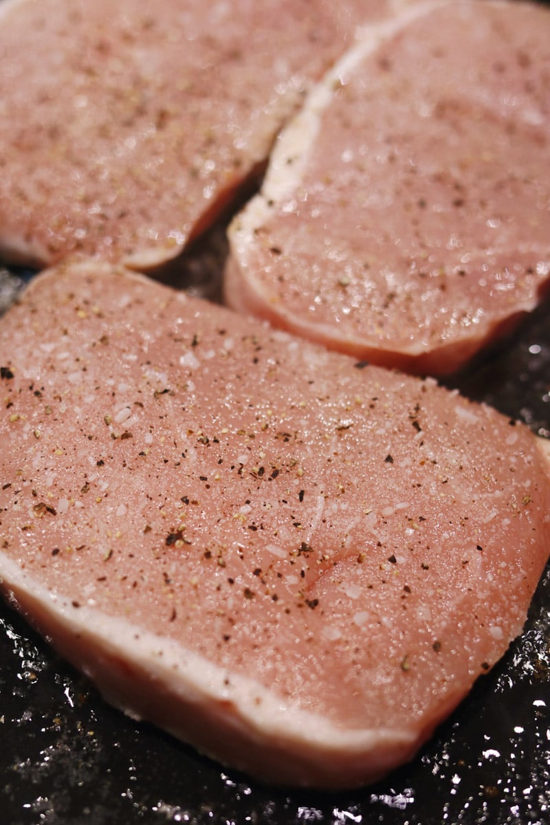 seasoned pork chops in a cast iron. 