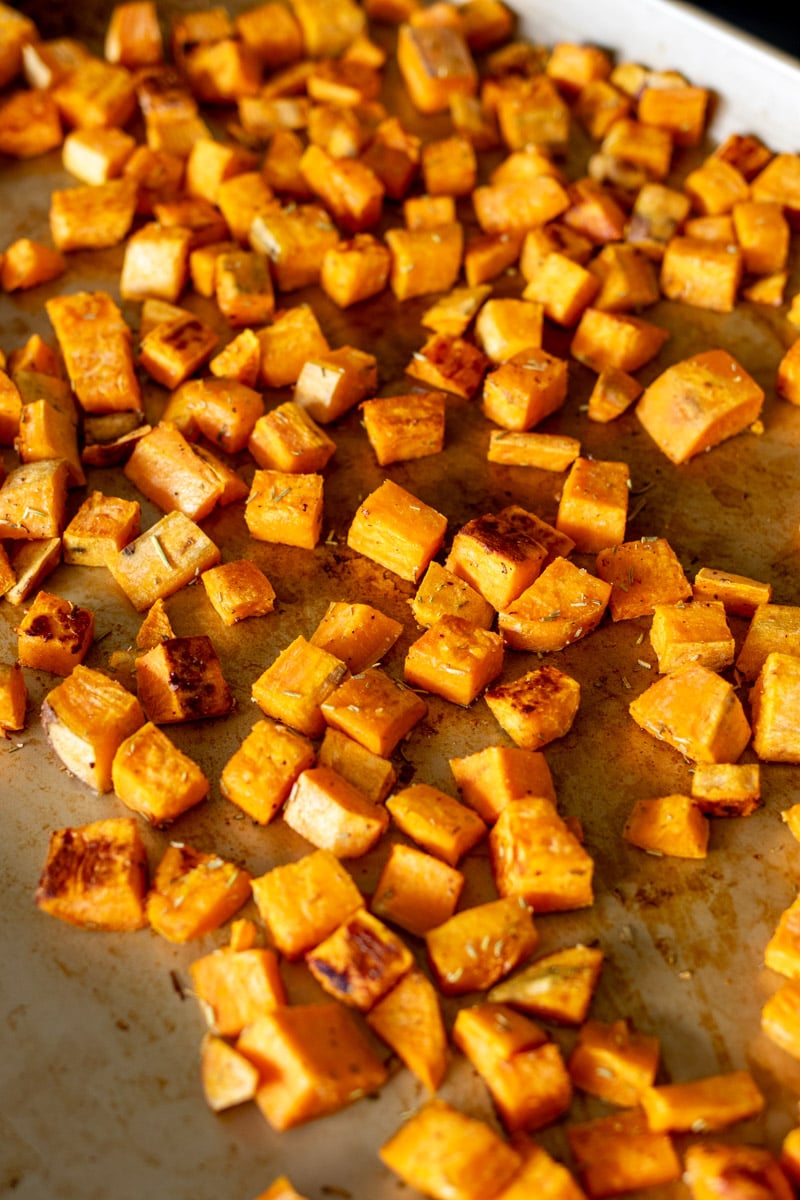 a baking dish full of rosemary roasted sweet potatoes. 