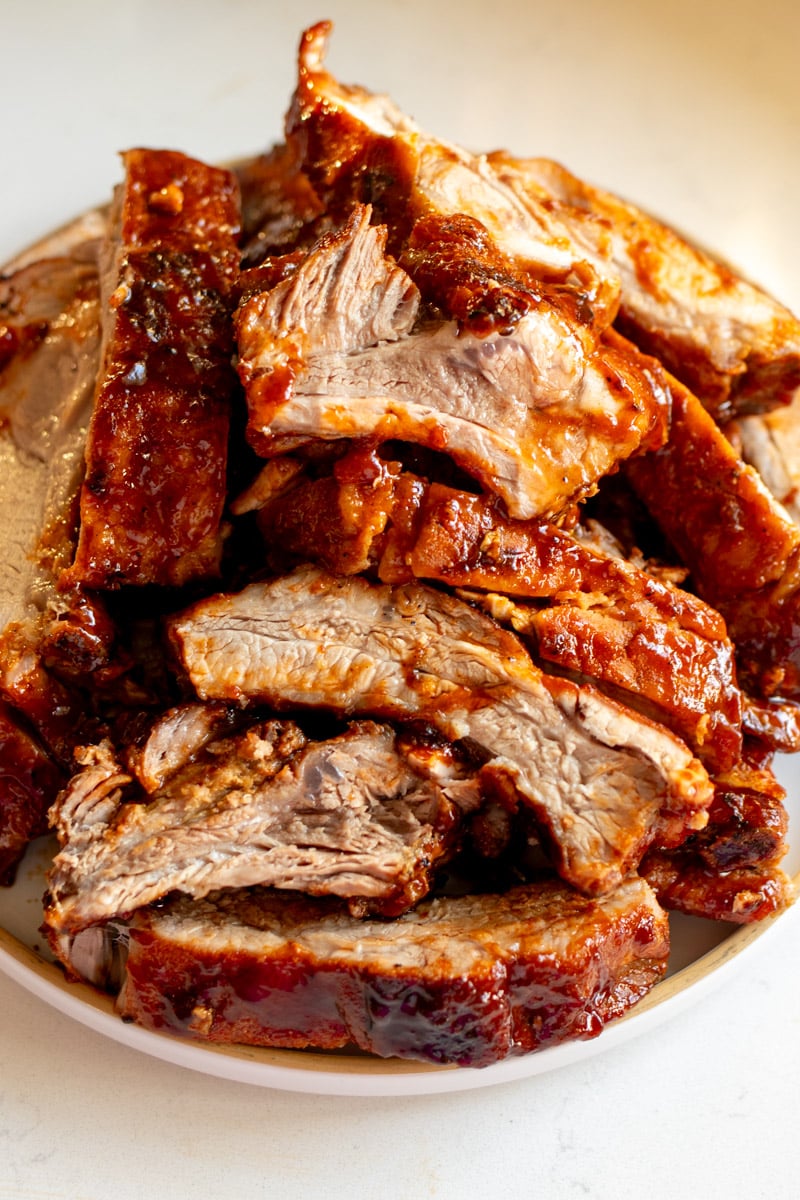 a big white plate full of chopped southern style ribs. 