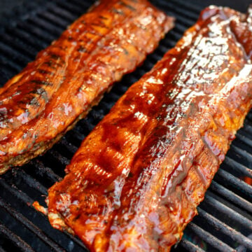 two racks of southern style ribs on the grill.