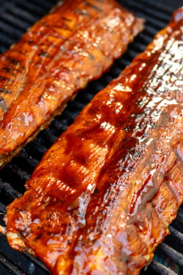 two racks of southern style ribs on the grill.