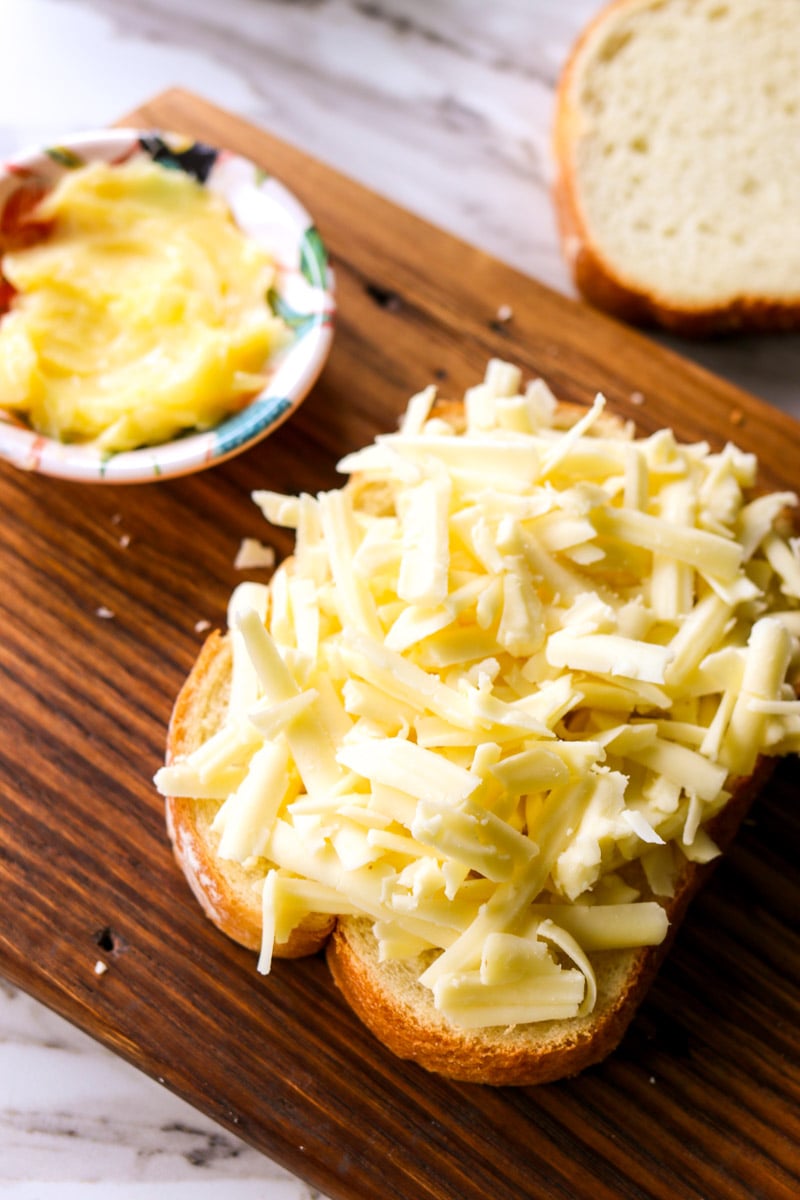 building an air fryer grilled cheese  on a cutting board.