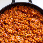 a pot of beautiful baked beans that are a warm acorn color.
