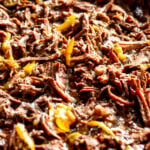 a close up image of pulled beef so you can see the fork tender texture.