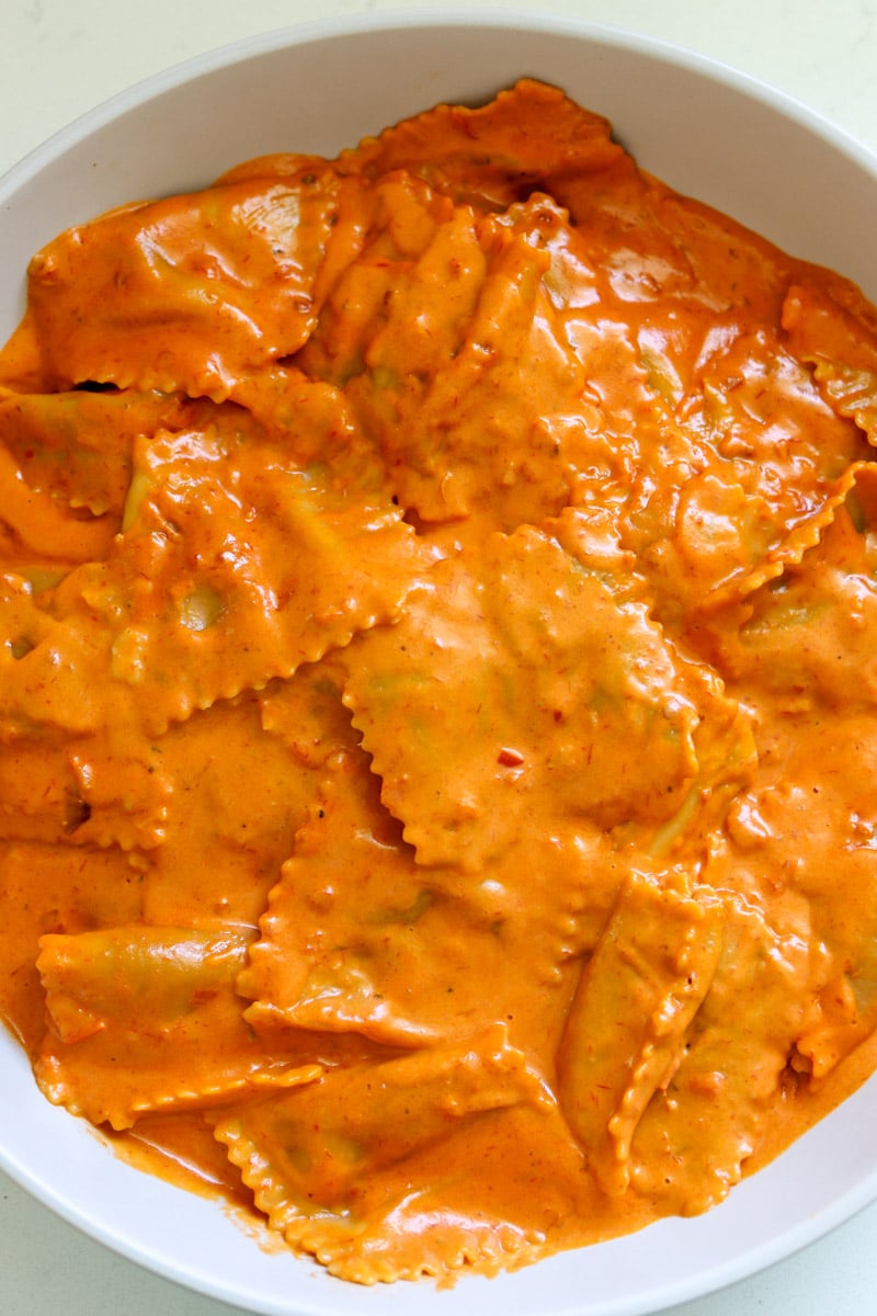 trader joe's burrata tomato ravioli with a deep orange reddish spicy vodka sauce.