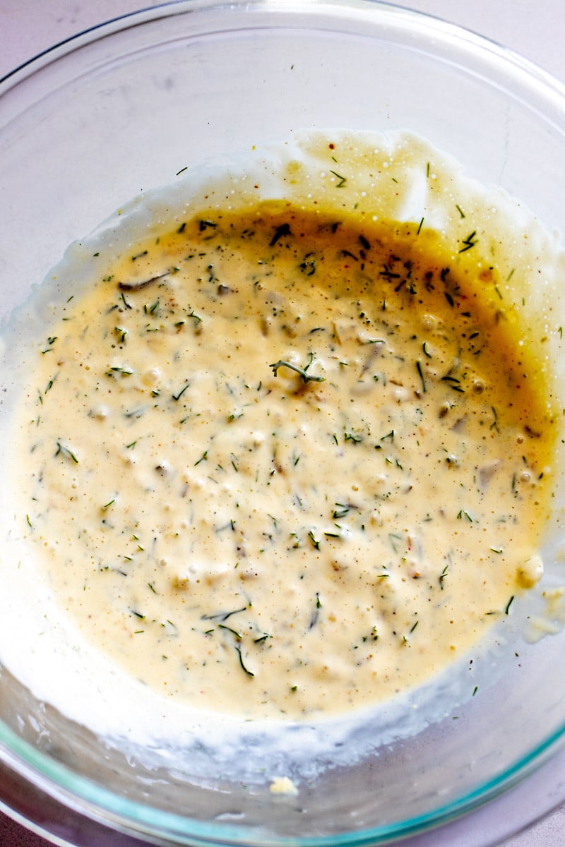 dill pickle pasta salad dressing in a glass bowl. 