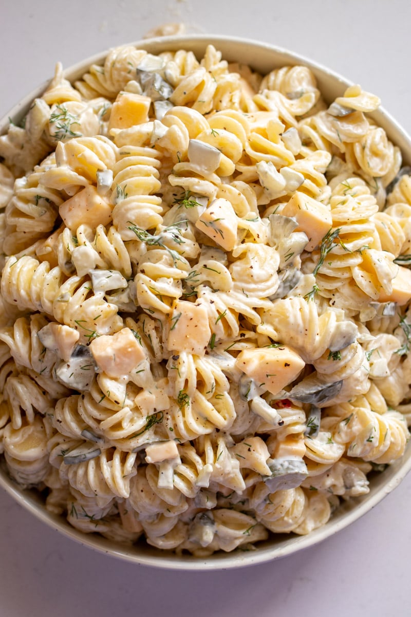 an overhead view of a big bowl of dill pickle pasta salad. 
