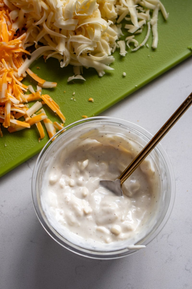ranch dressing with cheese in a glass bowl. 