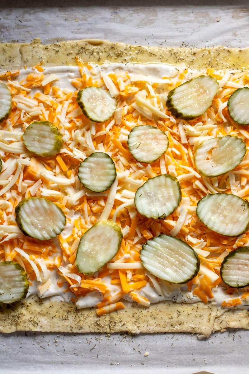 dill pickle chips on puff pastry with ranch and cheese. 