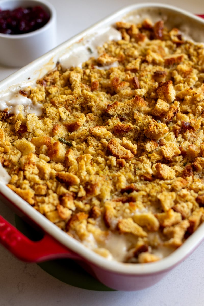 an overhead view of a freshly baked piping hot stove top stuffing chicken casserole recipe on a white countertop.