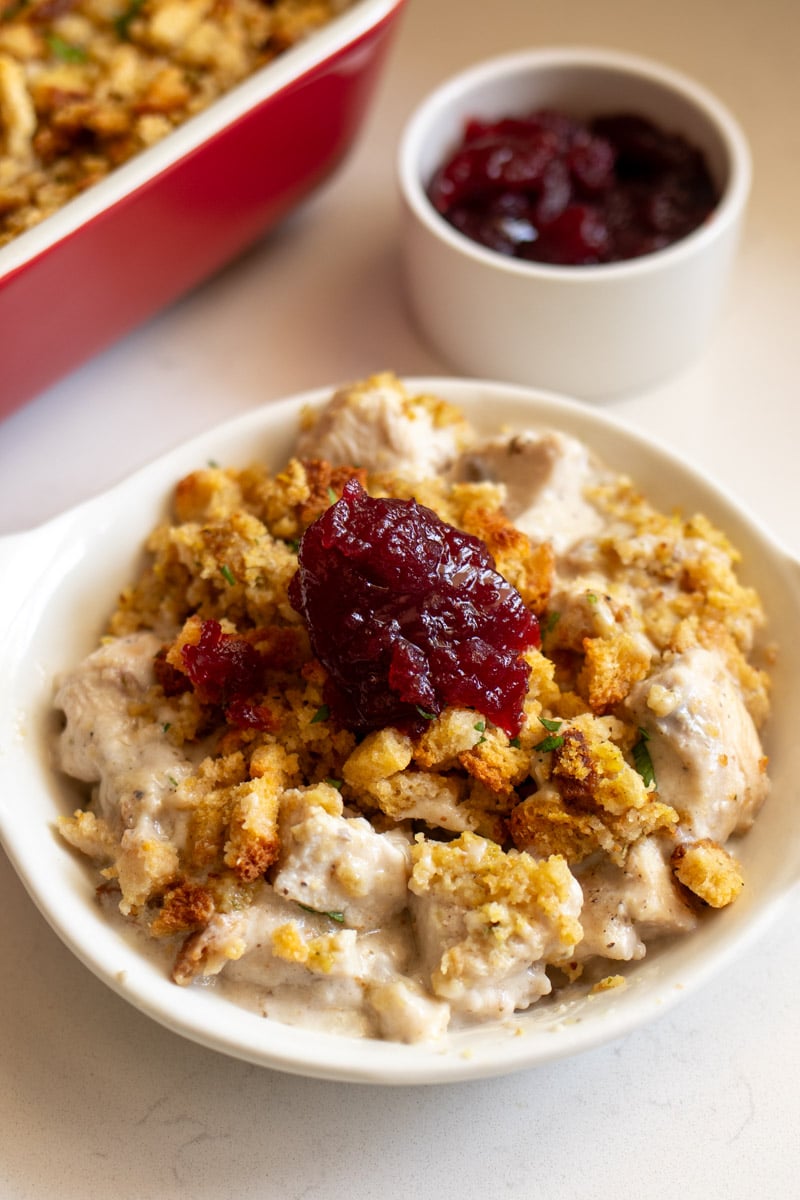 cranberry jelly on top of a bowl of stove top stuffing with chicken casserole.