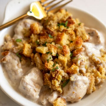 Stove Top Stuffing & Chicken Casserole in a cream bowl with a golden fork.