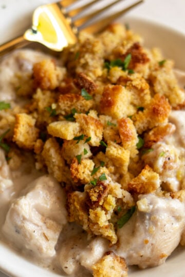 Stove Top Stuffing & Chicken Casserole in a cream bowl with a golden fork.