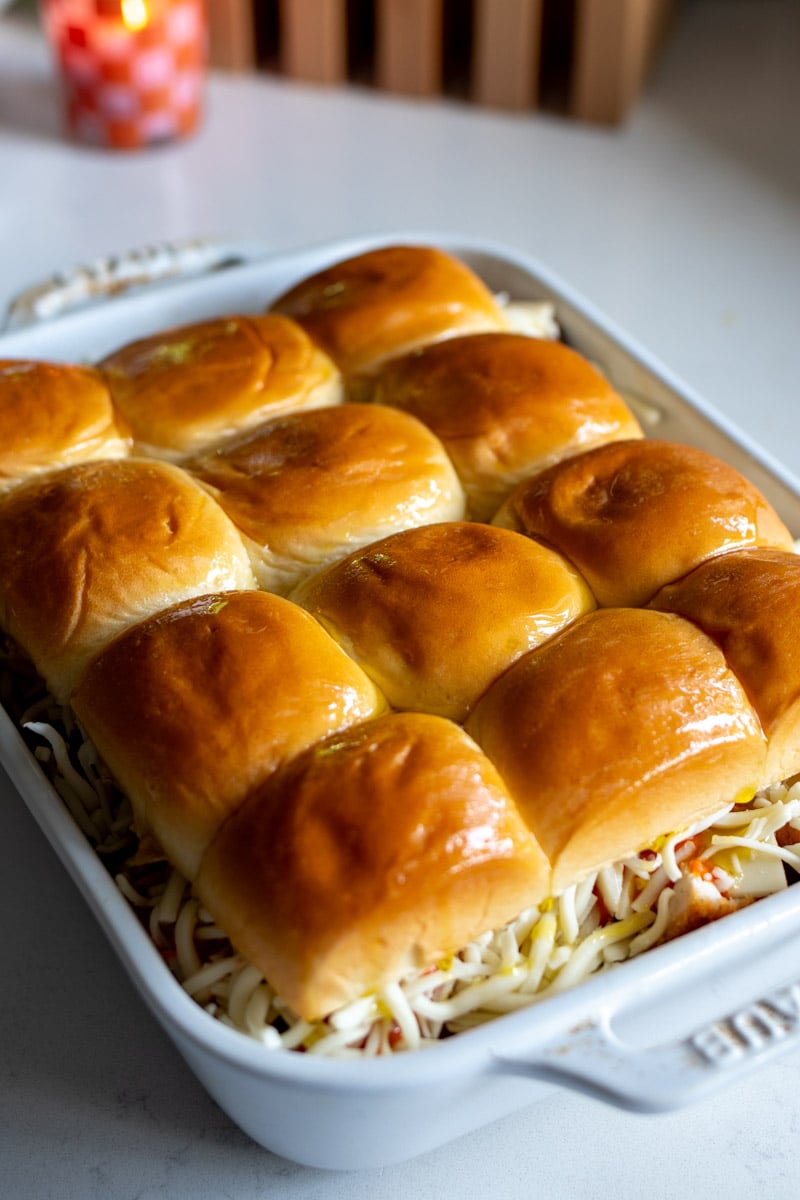 chicken parm sliders in a baking dish on a white countertop.