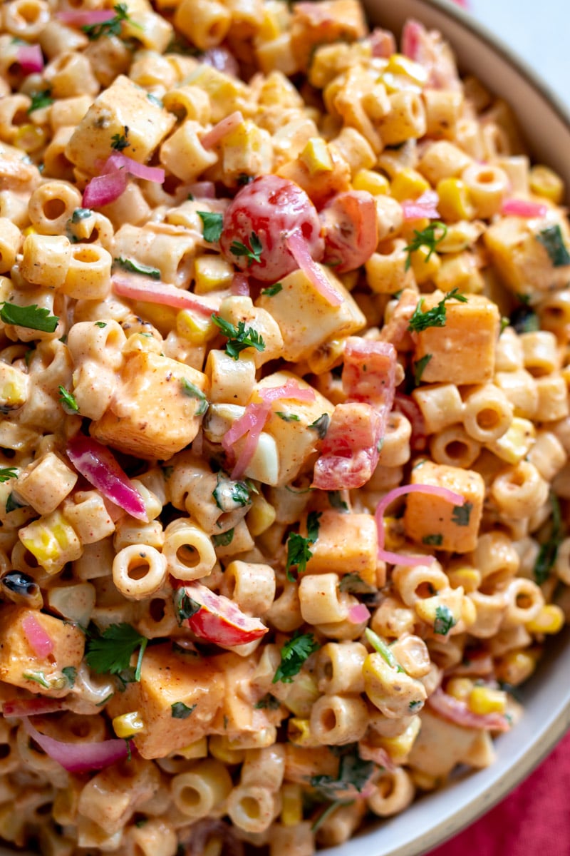 a close up of the texture in this elote pasta salad.