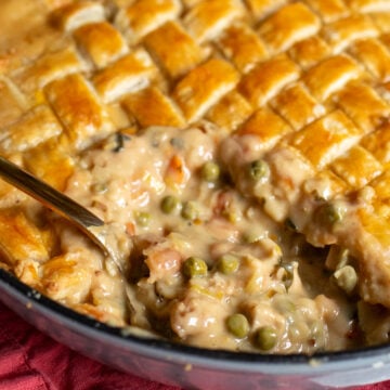 chicken pot pie with a spoon taking a scoop out.
