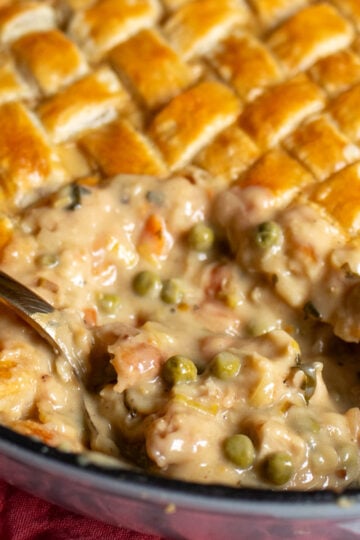 chicken pot pie with a spoon taking a scoop out.
